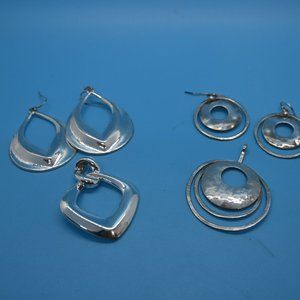 Two sets of silver pendants and matching earrings.